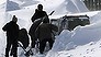 Policemen shovel snow around a vehicle of Kazuyo Miyashita along a road in Nakashibetsu, Hokkaido, northern Japan