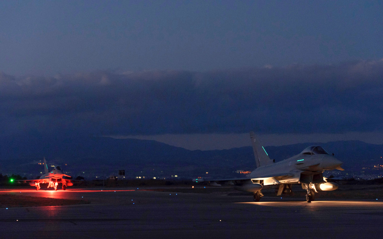 British Typhoon warplanes are seen on the ground after landing at the RAF Akrotiri, a British air base near the coastal city of Limassol, Cyprus, Thursday, Dec. 3, 2015. British warplanes carried out airstrikes in Syria early Thursday, hours after Parliament voted to authorize the attacks. (AP Photo/Pavlos Vrionides)