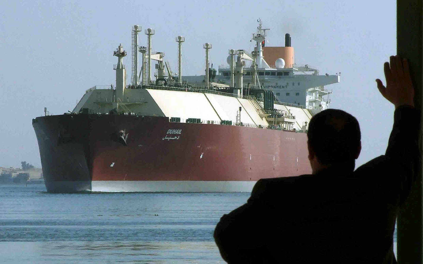 FILE PHOTO - A man looks as the world's biggest Liquefied Natural Gas (LNG) tanker, Qatari-flagged DUHAIL as she crosses through the Suez Canal April 1, 2008. REUTERS/Stringer/File Photo