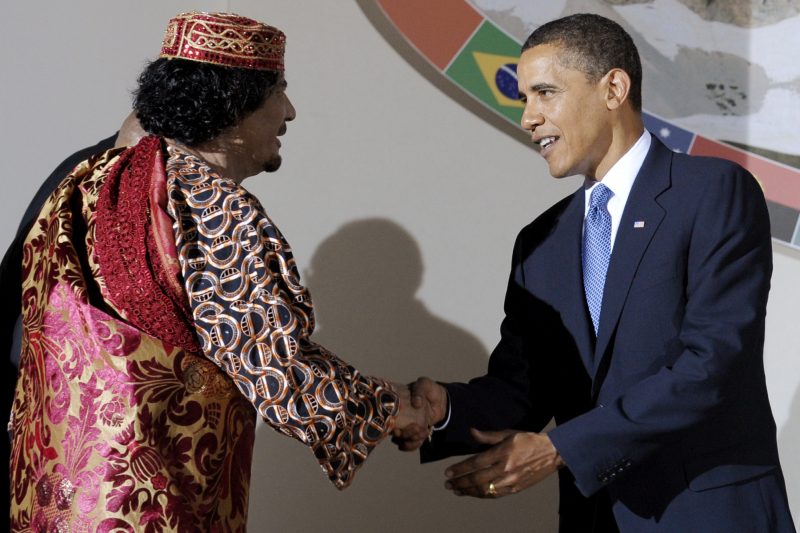 President Barack Obama greets one time ally of the United States, deposed Libyan leader Moammar Gadhafi, during the G8/G5 summit in L'Aquila, Italy, July 9, 2009. (AP/Michael Gottschalk)