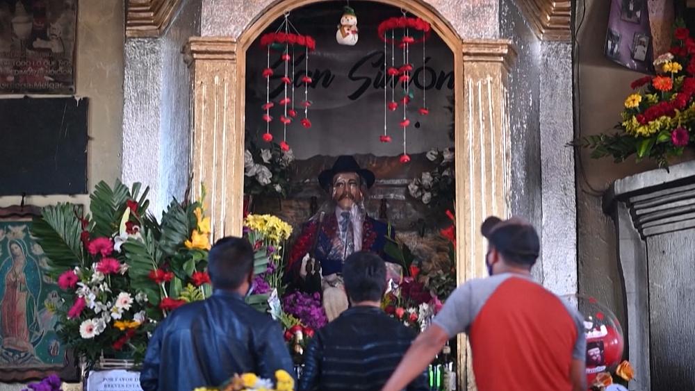 Guatemalans make offerings to folk hero San Simon for COVID protection