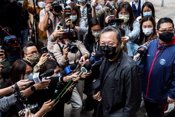 Hong Kong law professor and pro-democracy activist Benny Tai (C) speaks to the press outside Ma On Shan police station in Hon