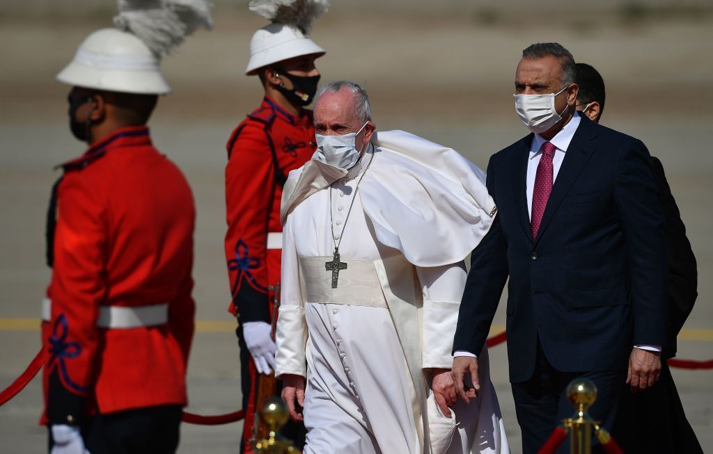 Pope Francis walks alongside Iraq's Prime Minister Mustafa al-Kadhem upon his arrival in Baghdad on March 5, 2021 on the firs