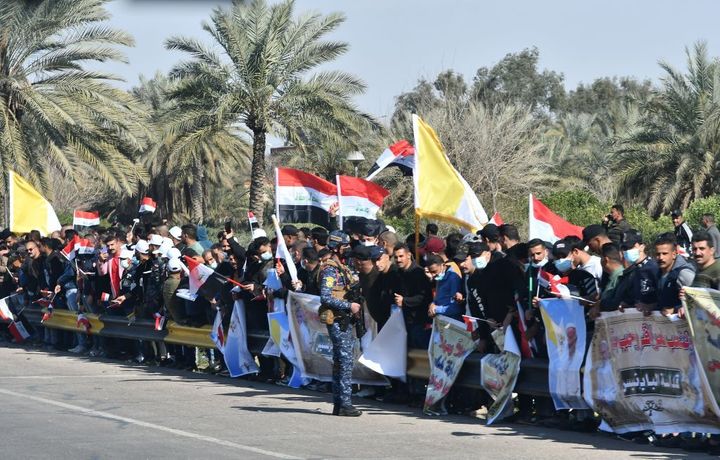 Iraqis line up along the road leading to Baghdad airport as they welcome the pontiff upon his arrival.