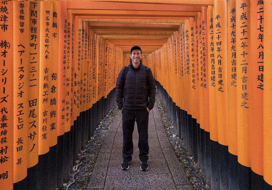 THE WRITER-PHOTOGRAPHER stands among some of the thousands of wooden gates that make up the Fushimi-Inari 