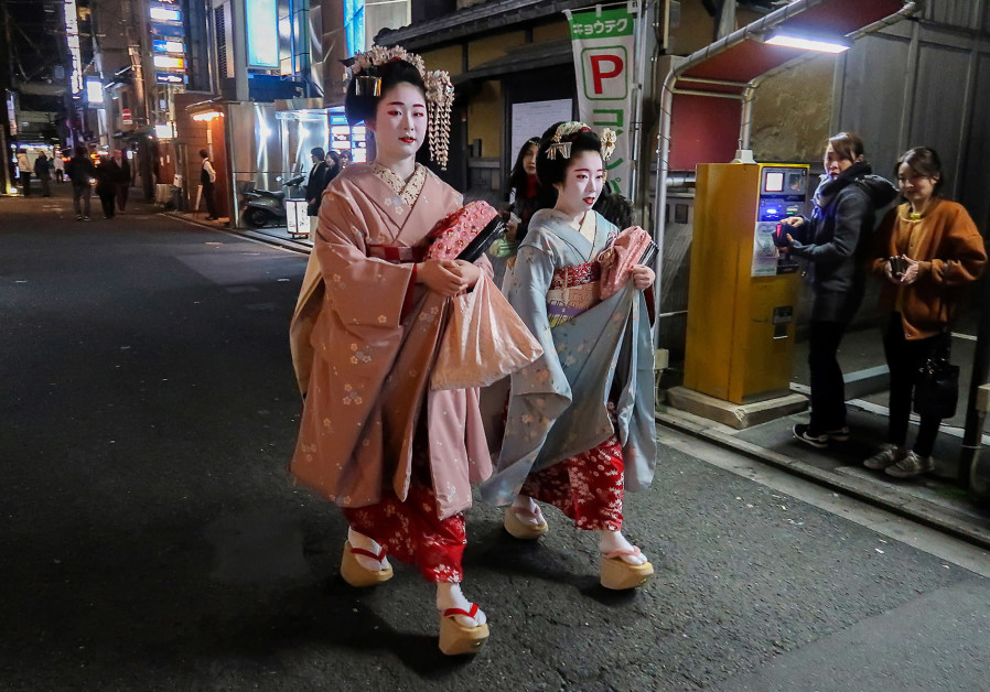 A PAIR of Geisha walk through the Gion neighborhood of Kyoto.