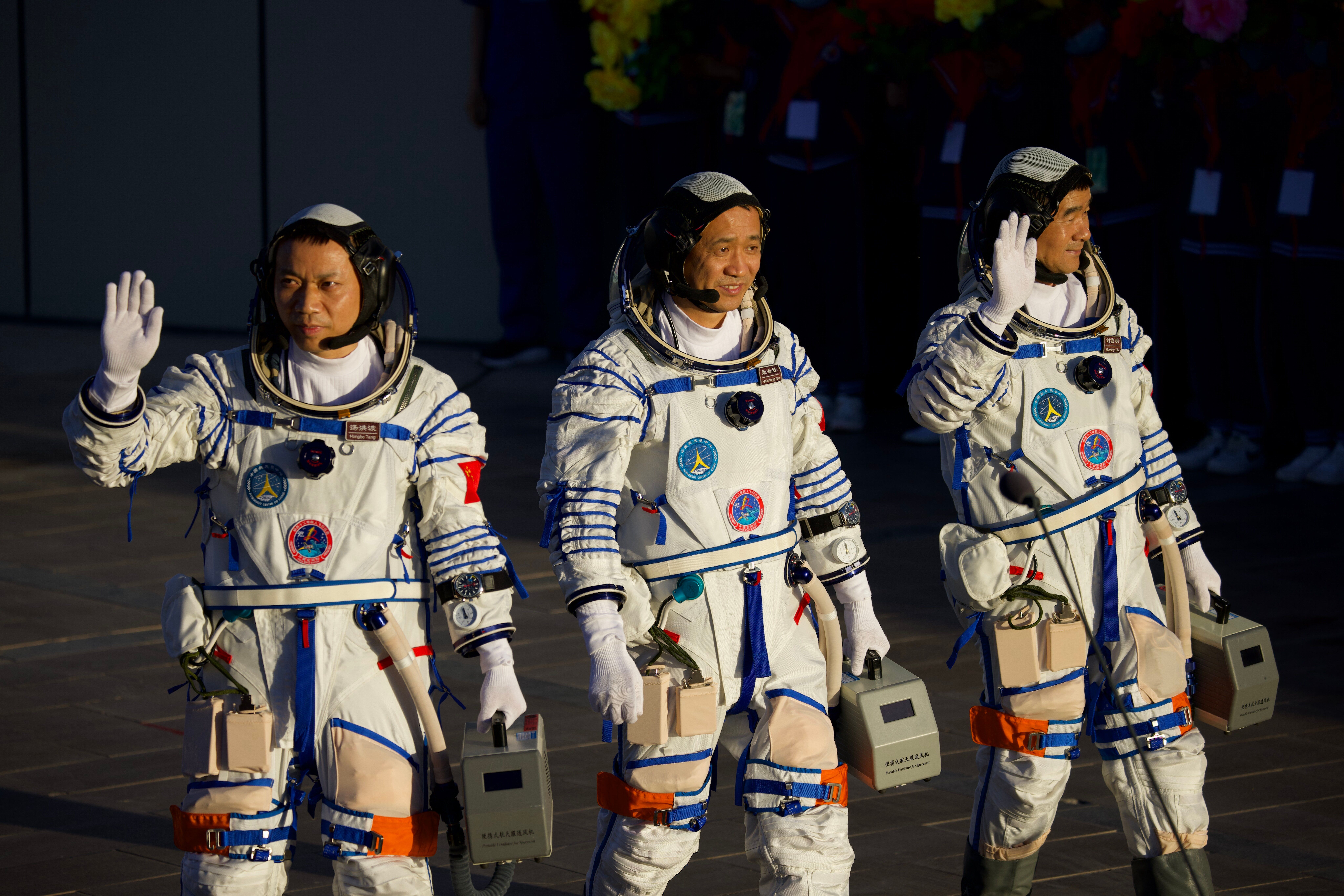 Astronauts (from left to right) Tang Hongbo, Nie Haisheng, and Liu Boming depart for the launch site of the Shenzhou-12 space