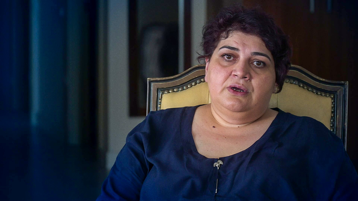 Khadija Ismayilova sits in front of a camera