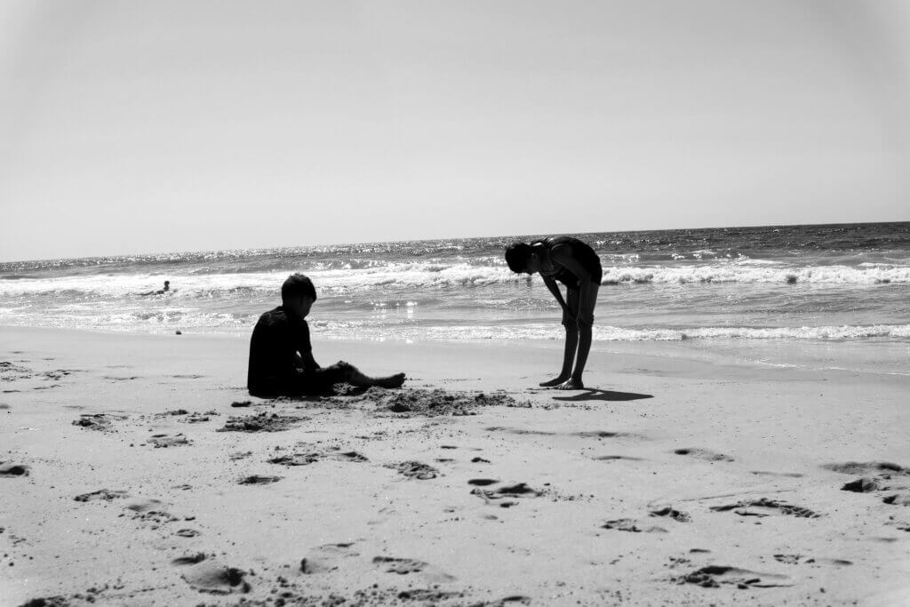 Two friends spend their afternoon under the blistering heat on a beach in western Gaza on August 11, 2021. (Photo: Mahmoud Nasser)