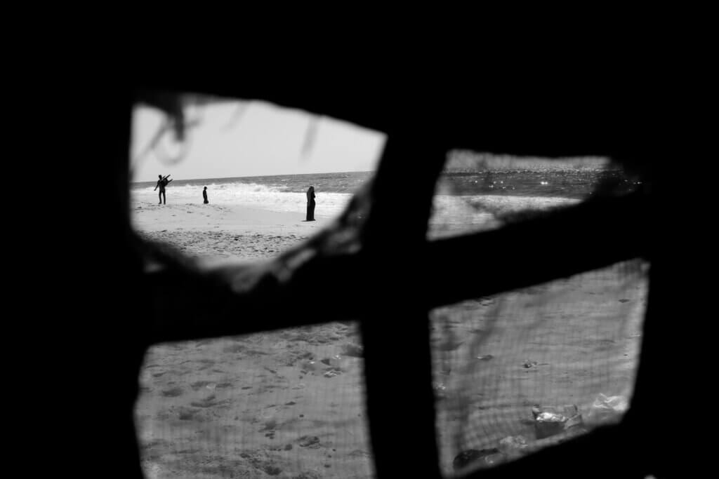 A mother, father, and their child scout the beach for a spot to set up in western Gaza on August 12, 2021. (Photo: Mahmoud Nasser)