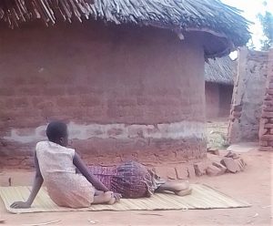 Harriet Nanzala rests alongside her daughter in eastern Uganda. (Morning Star News)