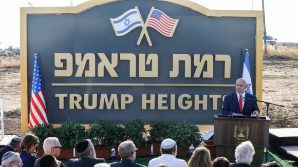 Prime Minister Benjamin Netanyahu gives a speech before the newly-unveiled sign for the new settlement of "Ramat Trump", or "Trump Heights" in the Golan Heights on June 16, 2019.