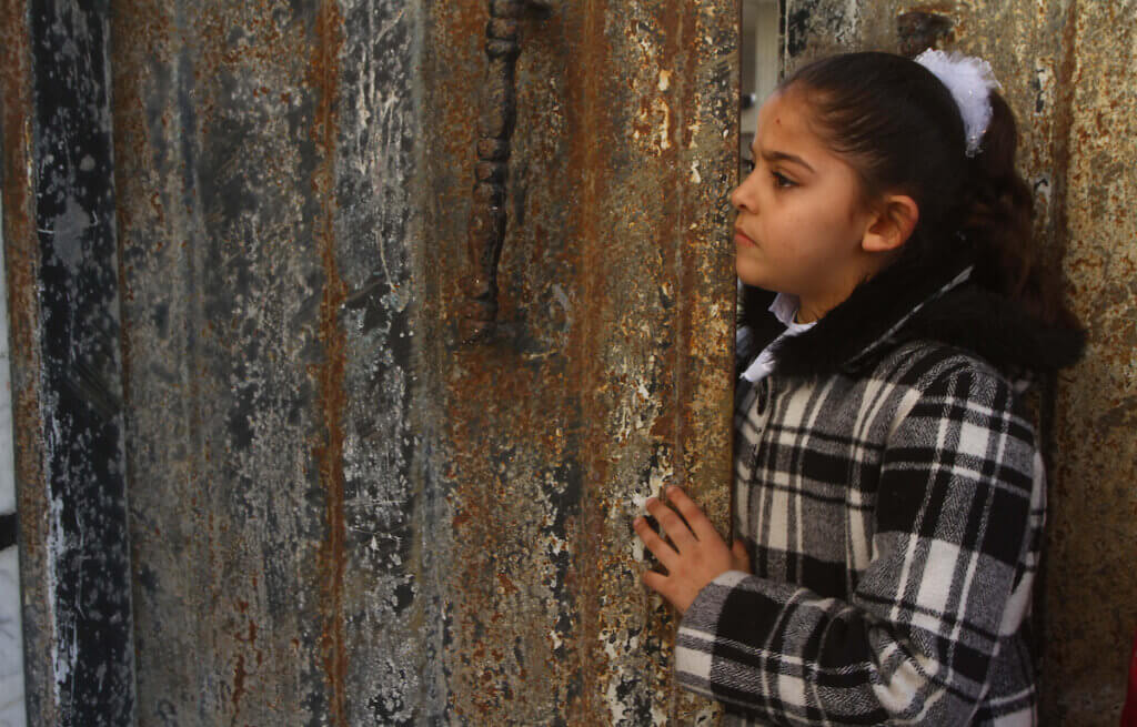 A Palestinian girl watches the funeral of Ramadan Bahajat Zaalan, 12, during his funeral in Gaza City in 2011. (Photo: Ashraf Amra/APA Images)