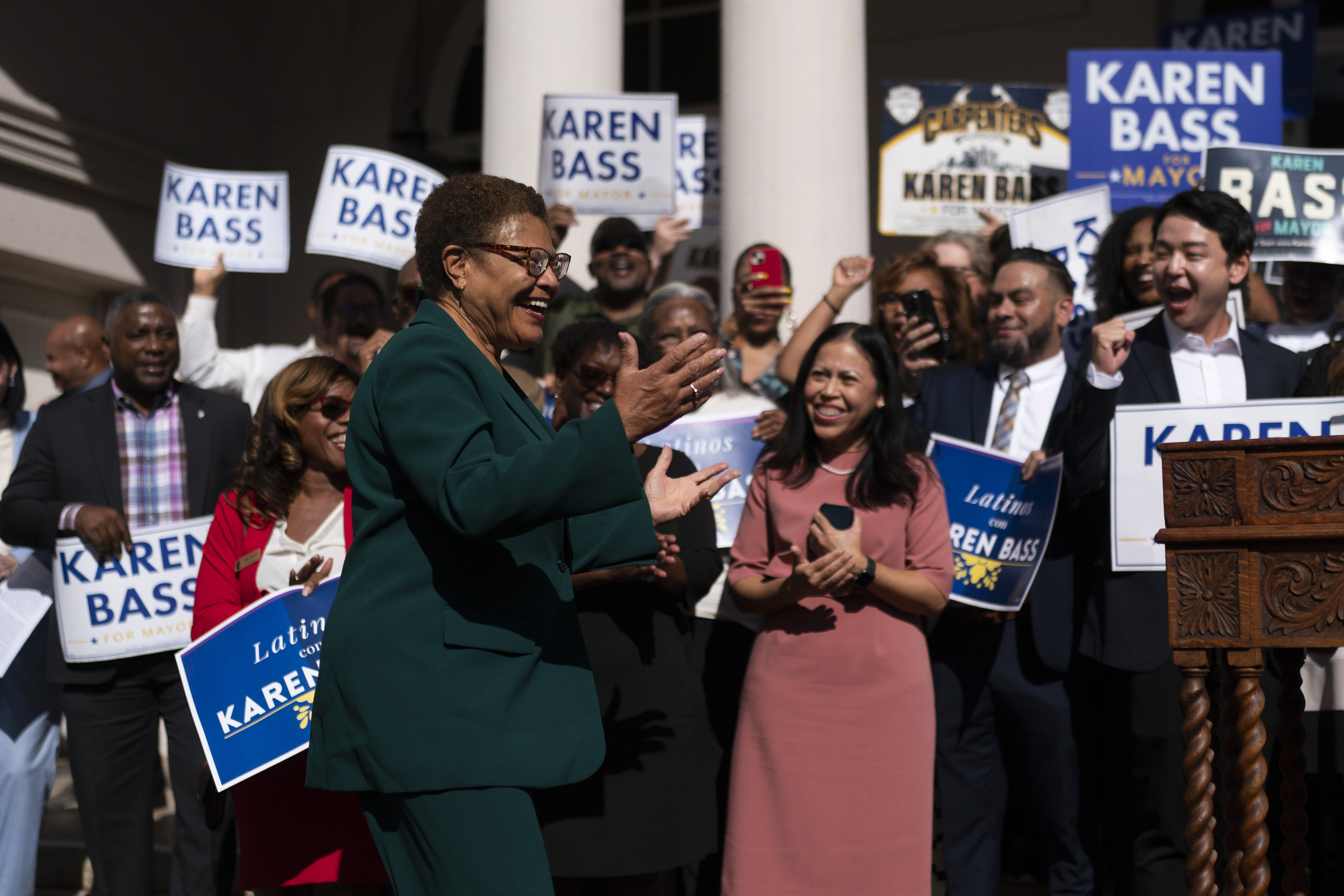 Karen Bass interacts with cheering supporters at a news conference in Los Angeles, Thursday, Nov. 17, 2022.