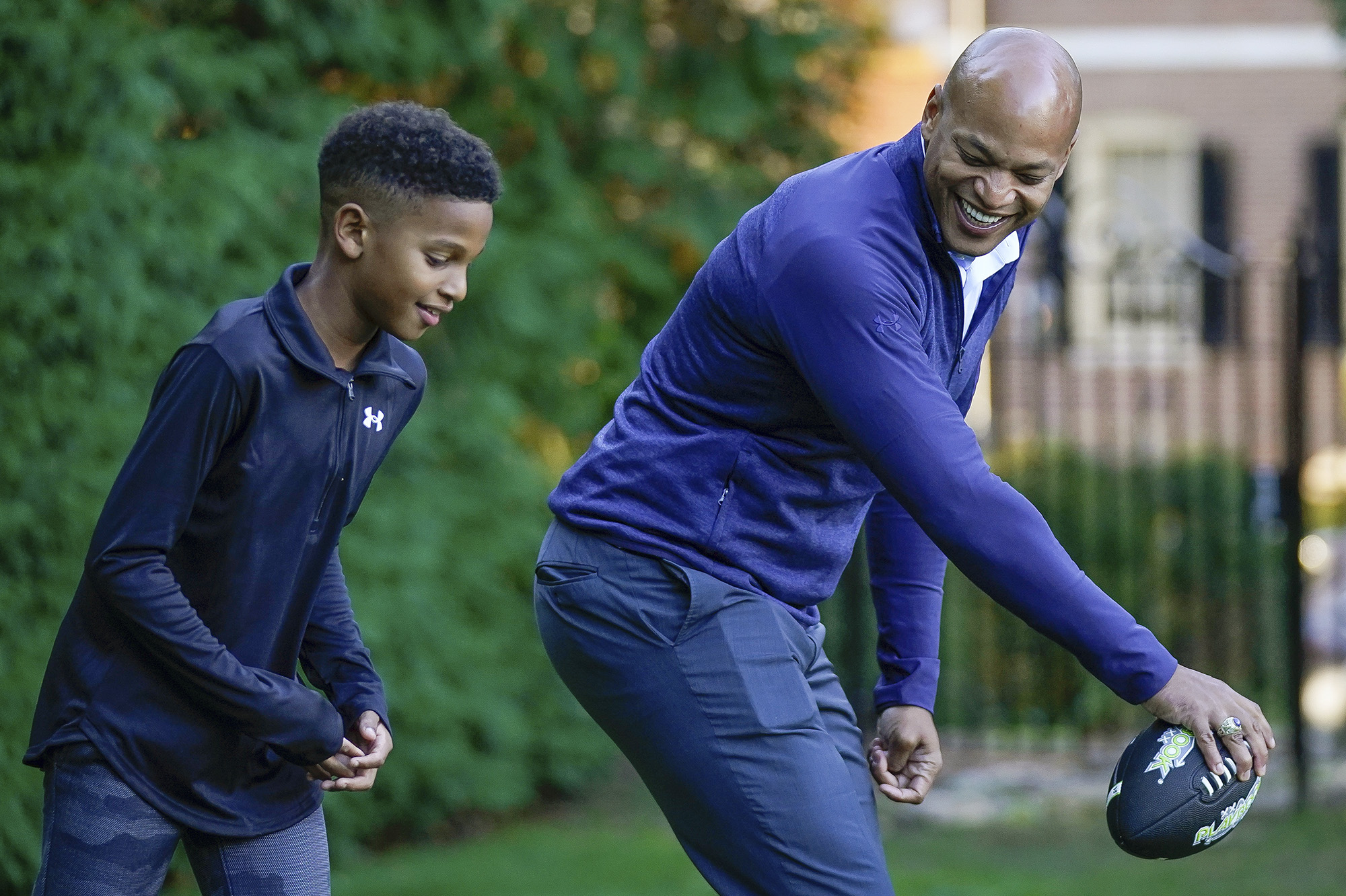 Maryland democratic gubernatorial nominee Wes Moore play football with his son, Jamie, while waiting for election results, on election night in Baltimore, Md., Tuesday, Nov. 8, 2022.