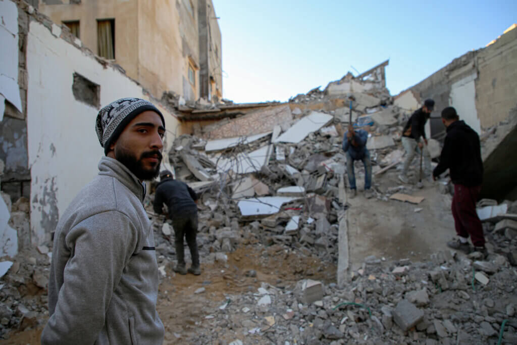 Khalil Al-Hinawi stands in front of his home, while Ministry workers demolish it with hammers, in Al-Shati Refugee Camp, Gaza, January 2023. “It is impossible to resettle anywhere else, my life is here,” says Hinawi. (Photo: Mohammed Salem)