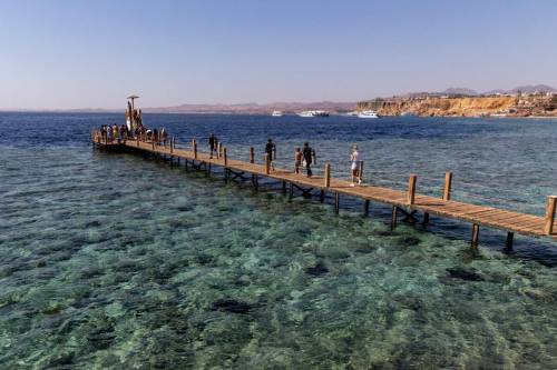 Tourist walk on a pier to enjoy diving to watch corals at the resort town of Sharm El Sheikh on Red Sea coast in South Sinai, Egypt on November 14, 2022 [Dominika Zarzycka/NurPhoto via Getty Images]