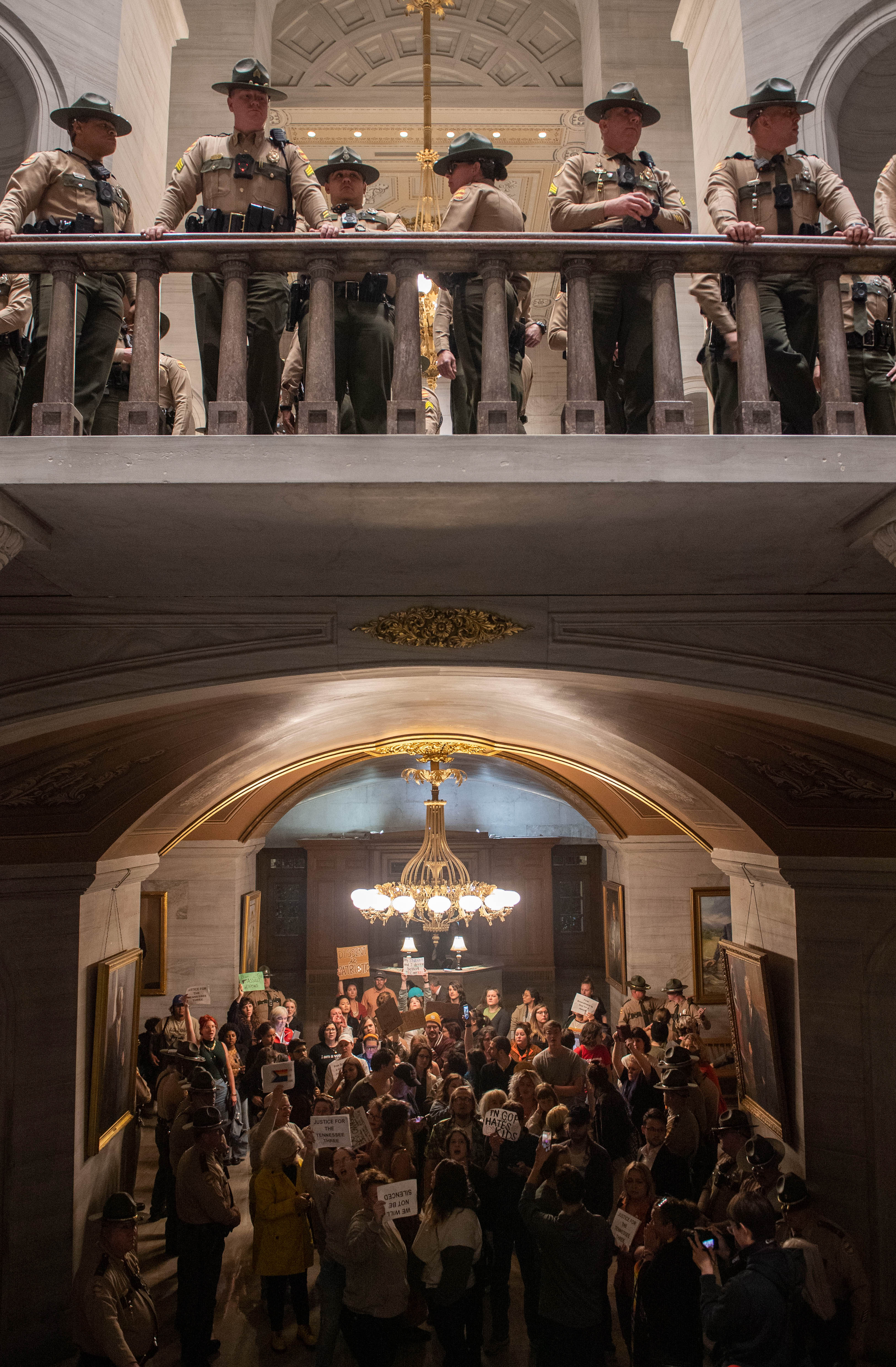 State Troopers watch the rotunda as people protest below after it was announced Republicans began the process of expelling three state representatives, during a House session at the Tennessee state Capitol Building in Nashville, on April 3, 2023.