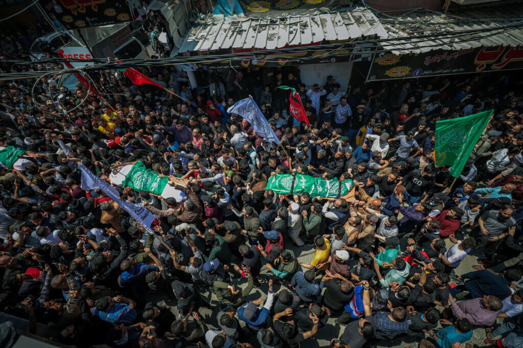 An overhead shot from the funeral of the 12 Palestinian martyrs killed during an overnight Israeli airstrike on Gaza, showing throngs of mourners carrying the bodies of the slain.