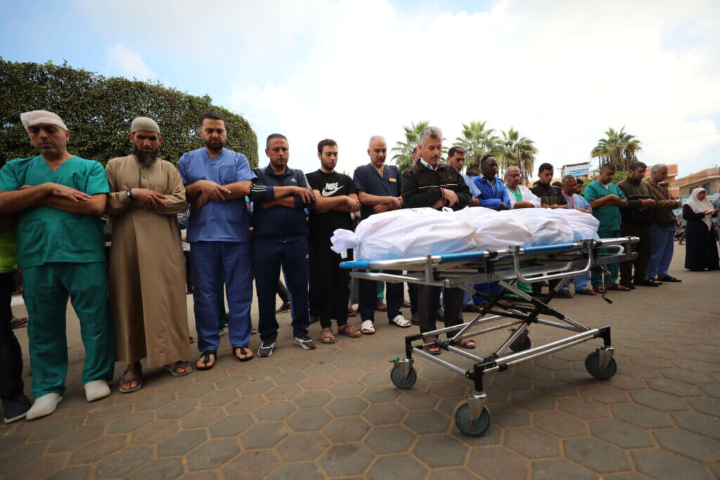 Palestinian doctors perform funeral prayers for the director of Al-Wafa Hospital, Medhat Muhaisen, who was killed in an Israeli air strike, at Al-Aqsa Hospital in Deir al-Balah, November 18, 2023. (Photo: Omar Al-Dirawi/APA Images)