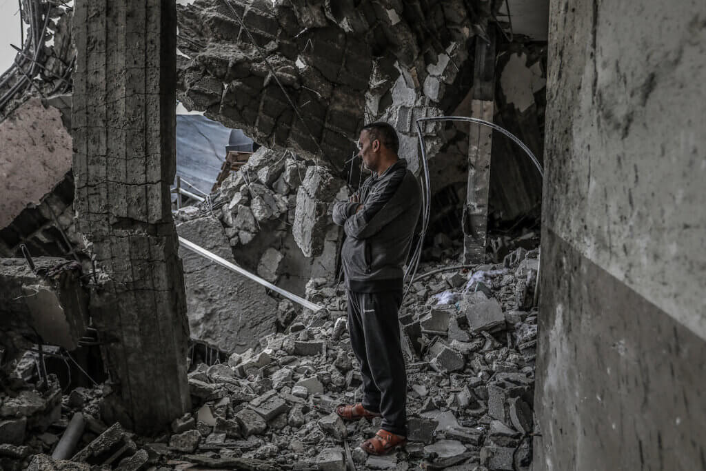 A Palestinian man inspects a destroyed building following an Israeli air attack on Rafah in the southern Gaza Strip, March 19 2024. (Photo: © Abed Rahim Khatib/dpa via ZUMA Press APA Images)