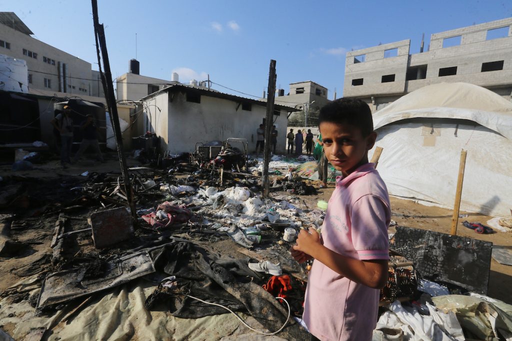 Palestinians inspect the site of Israeli strike that hit a tent area in the courtyard of Al Aqsa Martyrs Hospital in Deir al Balah, Gaza Strip, Sunday, Aug. 4, 2024. The strike killed several people including a woman and injured others, health officials confirmed. (Photo: Omar Ashtawy/APA Images)