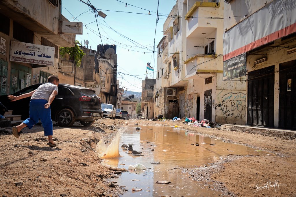 a Palestinian boy plays on the bulldozed roads of the Nur Shams refugee camp in Tulkarem in the occupied West Bank.